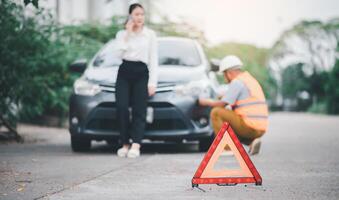 red emergency triangle on the road indicates that there is an accident or car breakdown on the road ahead. photo