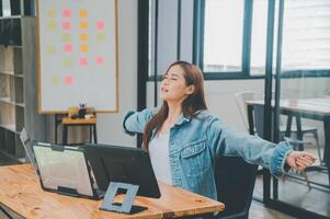 Female programmers are stretching oneself and relaxing after working and planning to work on programming, software coding and web design. Concept technology development. photo