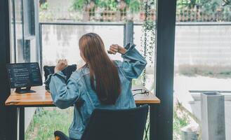 Female programmers are stretching oneself and relaxing after working and planning to work on programming, software coding and web design. Concept technology development. photo