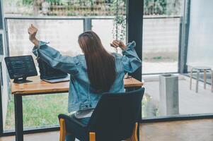 Female programmers are stretching oneself and relaxing after working and planning to work on programming, software coding and web design. Concept technology development. photo