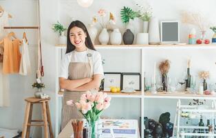 Small business owners pose smiling in their small shop to welcome customers and get customers online. And check the orders that customers have ordered of online retailers - online shopping. photo