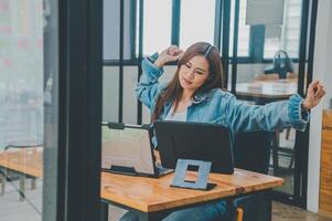 Female programmers are stretching oneself and relaxing after working and planning to work on programming, software coding and web design. Concept technology development. photo