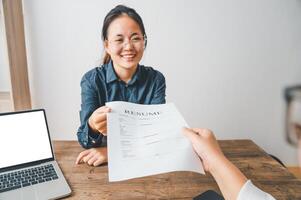 HR managers are interviewing job applicants who fill out their resume on the job application form in order to consider accepting a job as a company photo