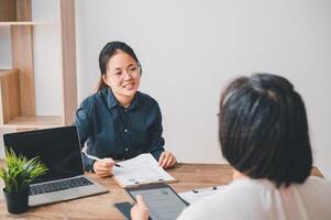 HR managers are interviewing job applicants who fill out their resume on the job application form in order to consider accepting a job as a company photo