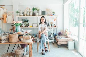 Small business owners pose smiling in their small shop to welcome customers and get customers online. And check the orders that customers have ordered of online retailers - online shopping. photo