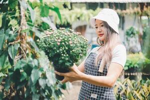 Young women doing hobbies taking care of plants, watering, shoveling flowers. In the garden during the break from work photo