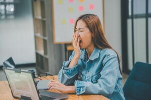Female programmers are sleepy and exhausted after working and planning to work on programming, software coding and web design. Concept technology development. photo