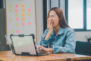 Female programmers are sleepy and exhausted after working and planning to work on programming, software coding and web design. Concept technology development. photo