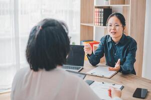 HR managers are interviewing job applicants who fill out their resume on the job application form in order to consider accepting a job as a company photo