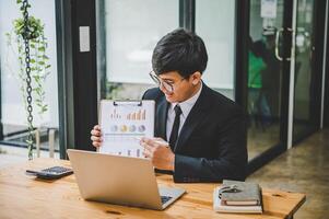 Businessman working online via call in team meeting with the charging of graphs for analysis, conceptual analysis and business planning photo