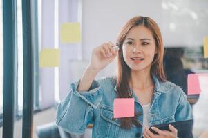 Web designers creating planning and analyzing with Colorful sticky notes on the office board.web design concept photo