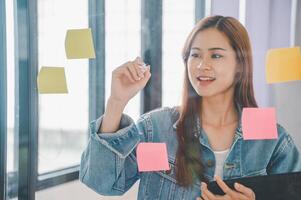 Web designers creating planning and analyzing with Colorful sticky notes on the office board.web design concept photo