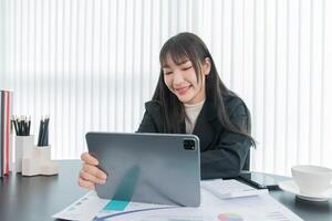 business woman working on the tablet ,discussing customer and checking business analytic document report working place in office. photo