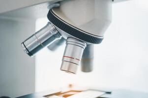 Female researchers are experimenting with pipette dropping a sample into a test tube in an experiment research in laboratory.. photo