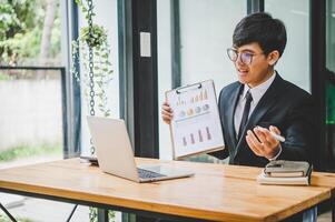 Businessman working online via call in team meeting with the charging of graphs for analysis, conceptual analysis and business planning photo