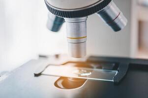 Female researchers are experimenting with pipette dropping a sample into a test tube in an experiment research in laboratory.. photo