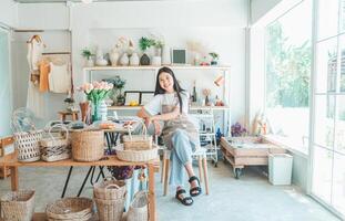 Small business owners pose smiling in their small shop to welcome customers and get customers online. And check the orders that customers have ordered of online retailers - online shopping. photo