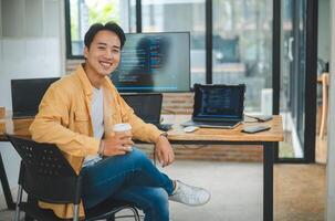 Young programmer working on coding, software development and web design in software company office.Concept technology development photo