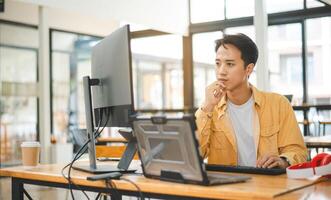 Young programmer working on coding, software development and web design in software company office.Concept technology development photo
