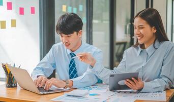 group of business people working and communicating together in the office With the charging of graphs for analysis, conceptual analysis and business planning photo