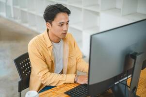 Young programmer working on coding, software development and web design in software company office.Concept technology development photo