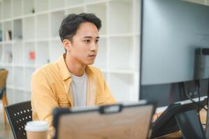Young programmer working on coding, software development and web design in software company office.Concept technology development photo
