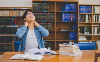 Students are relaxing after working on their laptops and searching for books to study, make reports, find useful information in the university room. photo