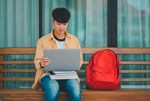 Students are doing research and finding knowledge on the internet on laptops in the university area. photo