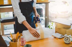 Online small business owners are packing their ordered products into the boxes for their customers based on the concept of online shopping - online shopping. photo