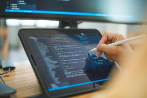 close-up hands programmer working on coding, software development and web design in software company office.Concept technology development photo