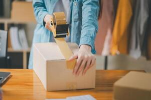 Online small business owners are packing their ordered products into the boxes for their customers based on the concept of online shopping - online shopping. photo