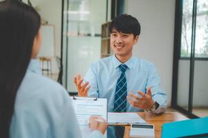 Job applicant introducing himself For a job interview after submitting a resume document to the Human Resources Manager for consideration for employment in the company. photo