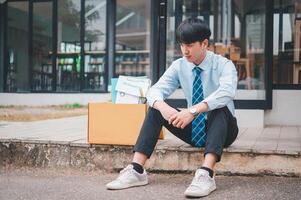 Young company employee stressed After resigning from work to find a new job , was fired by the company or when the employment contract expires, resulting in being unemployed photo