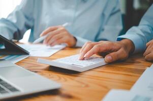 close up The business person is sitting on a calculator with a graph in the office of finance accounting concept photo
