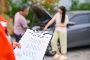 male insurance officer came to help inspect a customer's car that had an accident. Concept for vehicle crash, insurance claim. photo