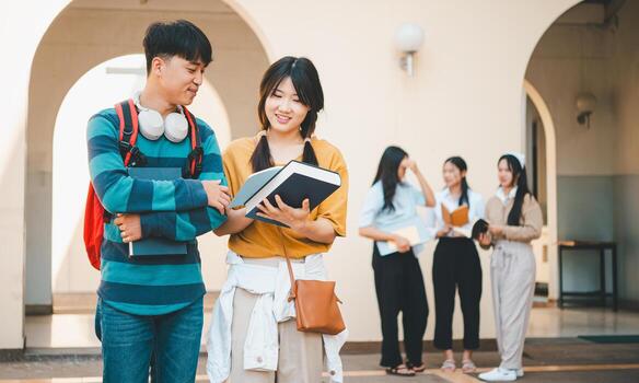 group of students young university students consulting doing homework, cooperating research plan Discuss concepts and strategies. Prepare presentations on laptops and tablet computers. photo