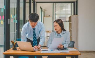 group of business people working and communicating together in the office With the charging of graphs for analysis, conceptual analysis and business planning photo