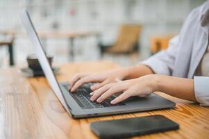 Close-up of a student's hand at work on a laptop. Learning and searching for information on the internet. photo