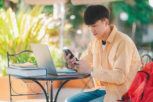 Students are doing research and finding knowledge on the internet on laptops in the university area. photo