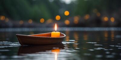 An candle is floating on a small boat in a pond. photo