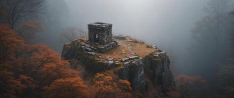 Aerial View of an Ancient Stone Structure in a Foggy Forest. photo