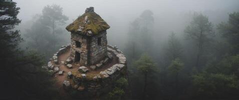 Aerial View of an Ancient Stone Structure in a Foggy Forest. photo
