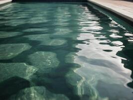A pool with a green water and a white tile floor. photo
