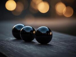 A black background with three black round objects on it. photo