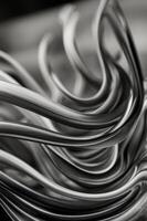 A black and white image of a series of lines that are curved and twisted. photo