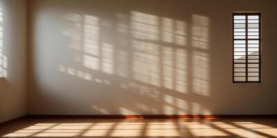 Sunlight is casting geometric shadows from a large window onto the floor of an empty room. photo