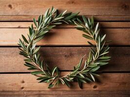 Olive Branch Wreath Framing a Rustic Wooden Background. photo