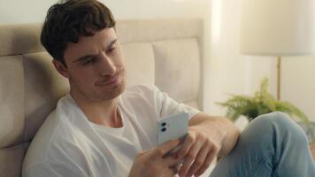 Caucasian European man bed using mobile phone smartphone error broken failure telephone gadget technology guy male notification displeased problem spam internet mistake social networks connect bedroom photo