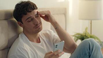Caucasian European man bed using mobile phone smartphone error broken failure telephone gadget technology guy male notification displeased problem spam internet mistake social networks connect bedroom photo