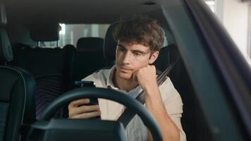 Caucasian confused sad driver upset puzzled male businessman frustrated man stressed business employer in car auto automobile parking lot traffic jam gadget addict lost problem bad news mobile phone photo